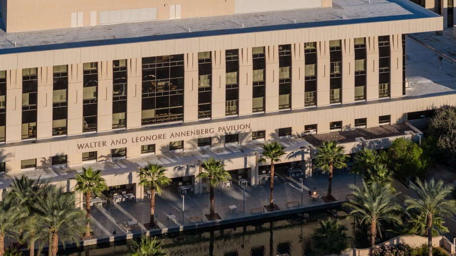Annenberg Pavilion signage above a palm-lined terrace at Eisenhower Medical Center.
