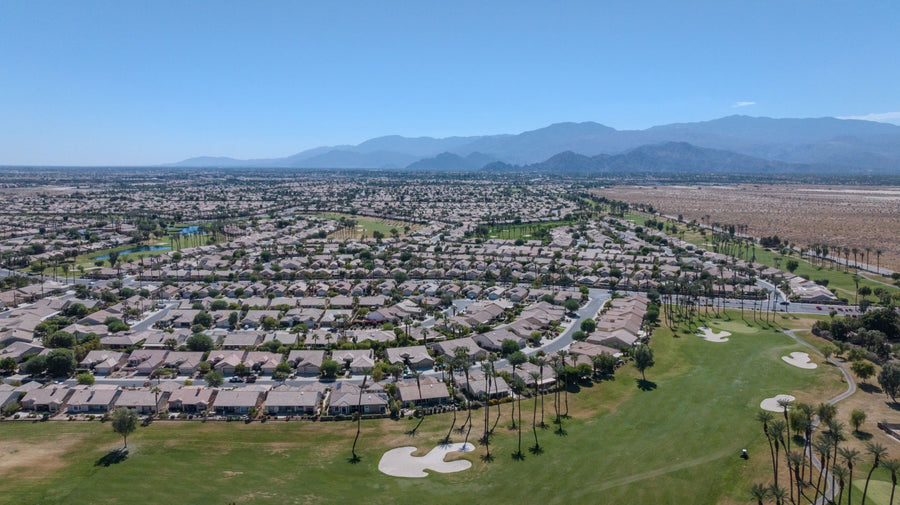 Original aerial photograph by Mark Miller of Sun City Palm Desert homes, golf fairways, lakes and distant mountains, October 7, 2026.