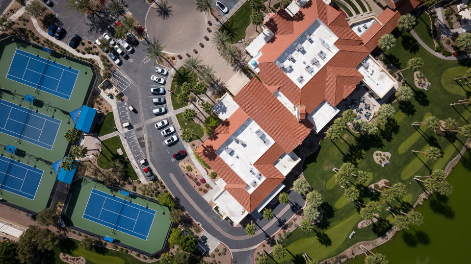 Mark Miller’s aerial photograph of the Montecito Clubhouse at Sun City Shadow Hills, with tennis courts, parking and landscaped grounds.