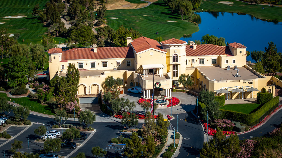 Classic Club clubhouse, golf fairways and lake in Palm Desert, photographed from above