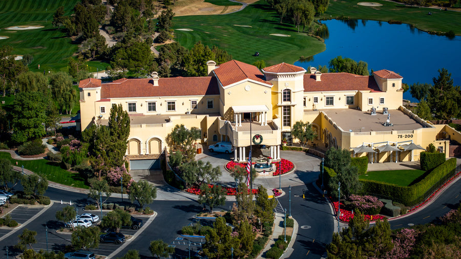 Classic Club clubhouse, golf fairways and lake in Palm Desert, photographed from above