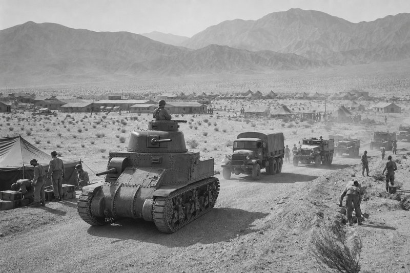 Black-and-white editorial reconstruction of Camp Young in 1942, with soldiers, an M3 Lee tank, military trucks and tents in the desert east of Indio.