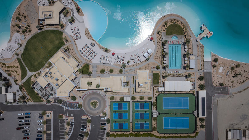 Aerial view of the Artisan Club at Cotino, showing the lagoon beach, lap pool, pickleball courts and tennis courts
