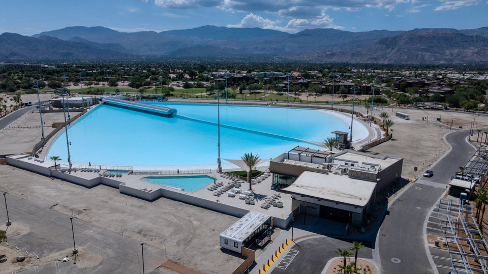 Aerial overview of DSRT SURF in Palm Desert showing the filled surf lagoon, pool deck, buildings and surrounding site on September 10, 2026.