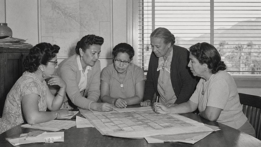 AI-generated historical reenactment of five Agua Caliente women leaders reviewing Palm Springs land plans; not an archival photograph.