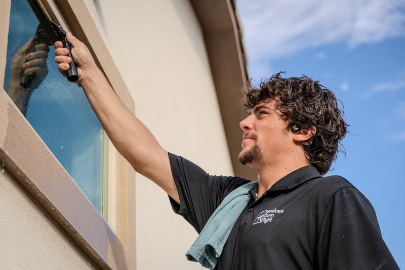 Landon Dunn of Windows Dunn Right cleaning an exterior window in the Coachella Valley.