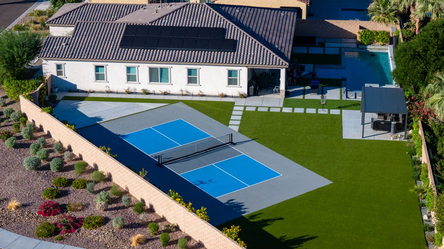 Drone view of Matt Anderson’s blue pickleball court and landscaped backyard in La Quinta