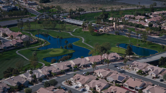 Aerial view of Sun City Palm Desert entrance, golf course and homes