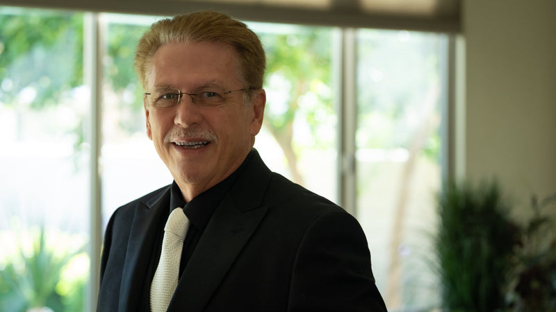 Paul David, Coachella Valley singer, in a black suit and light tie. Photo by Mark Miller.