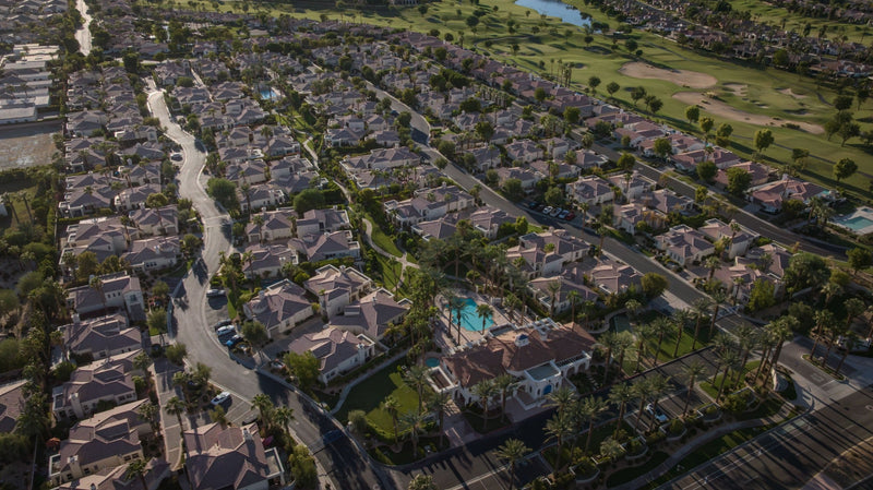 Wide aerial view of Puerta Azul beside PGA West golf course