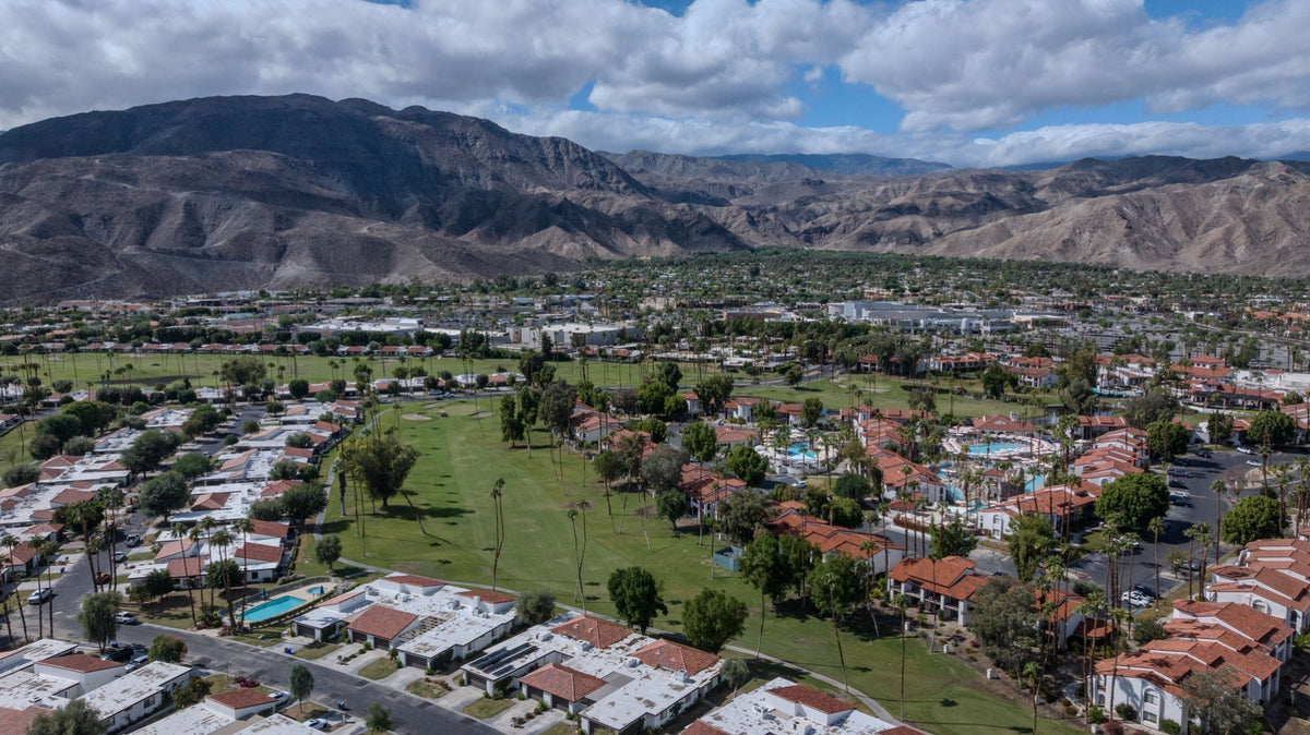 Aerial view of Rancho Las Palmas homes, golf course and mountain backdrop