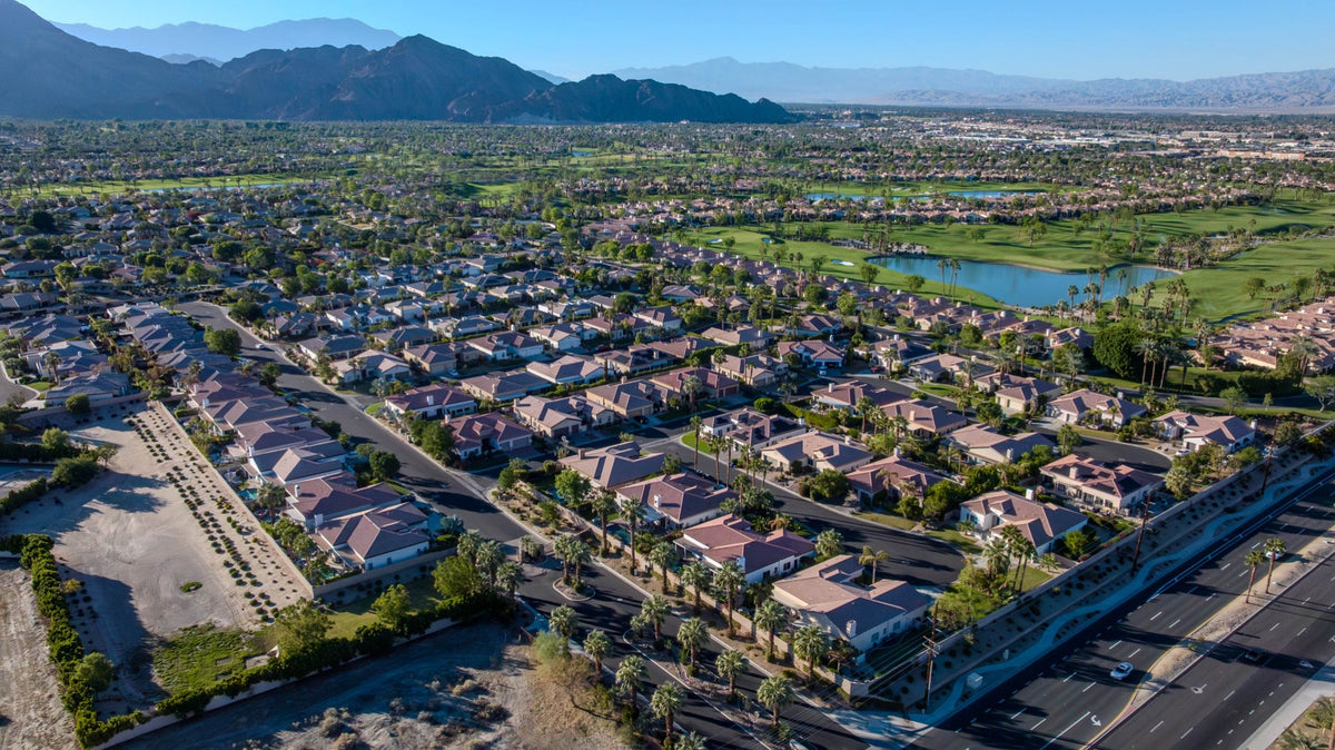 Aerial view of Renaissance homes with surrounding golf courses and mountains