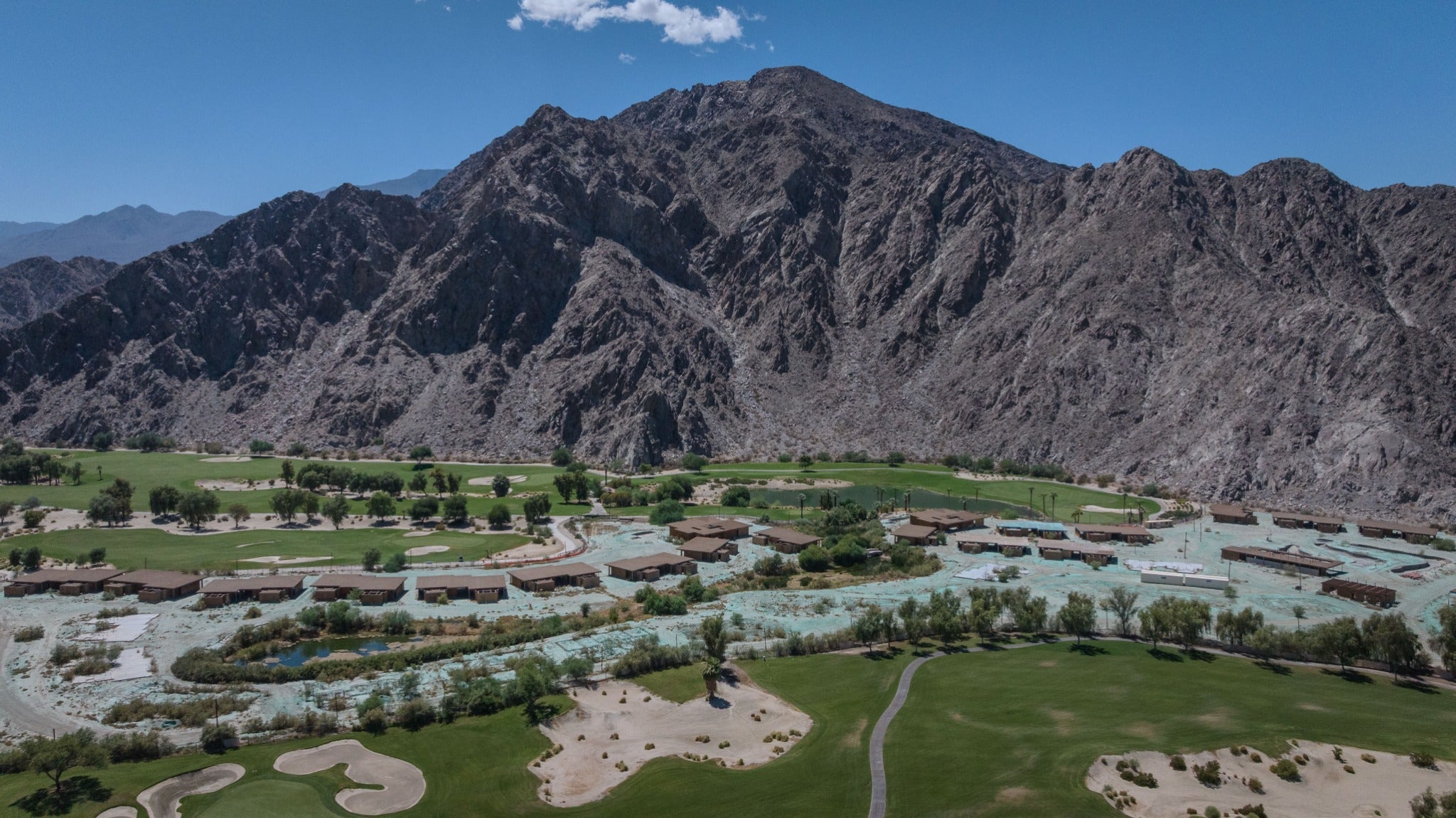 Aerial view of unfinished structures beside the SilverRock golf course and Santa Rosa Mountains in La Quinta