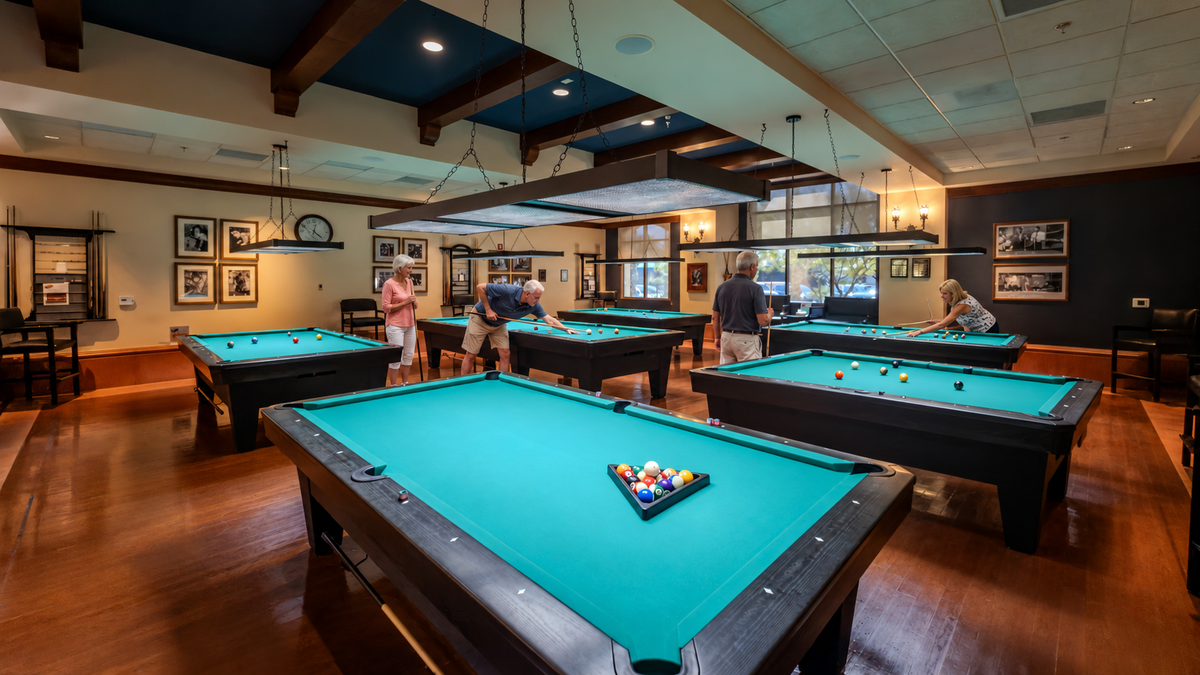 Sun City Shadow Hills billiards room with pool players added using AI to Mark Miller’s original photograph.