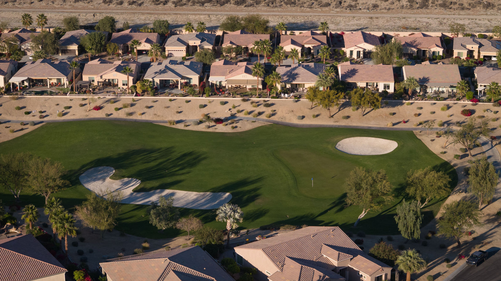 view of sun city shadow hills golf course and homes from a drone