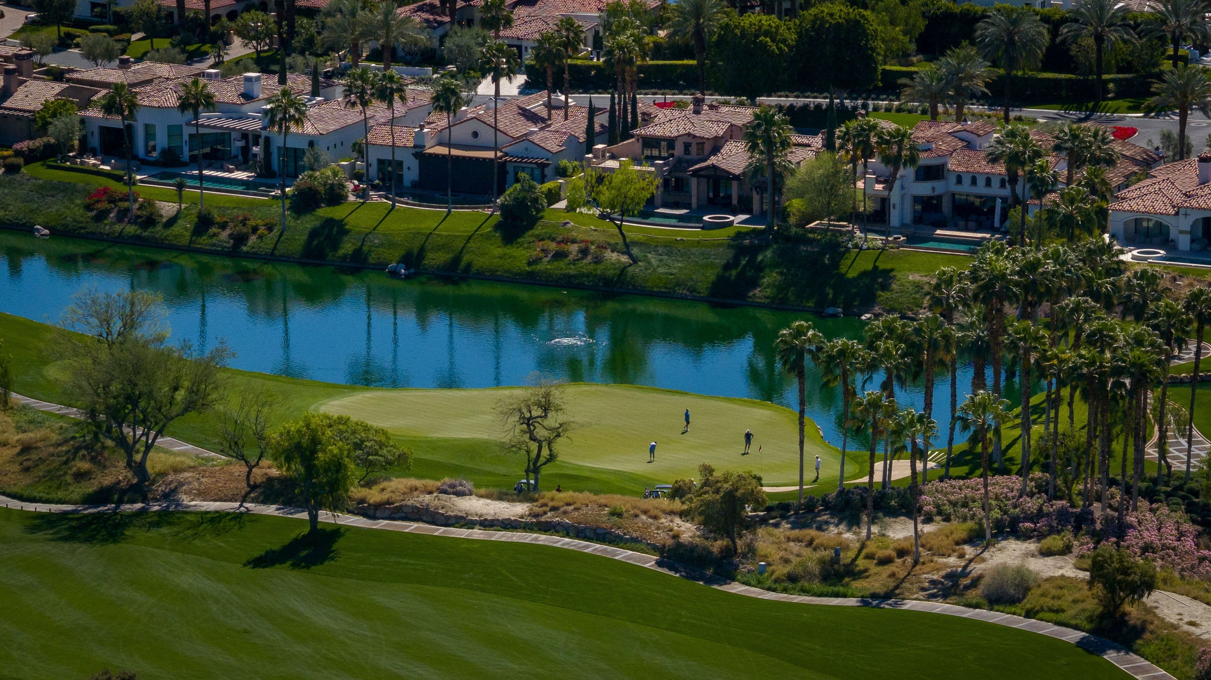 Aerial view of luxury homes, fairway and lake at The Hideaway Golf Club in La Quinta