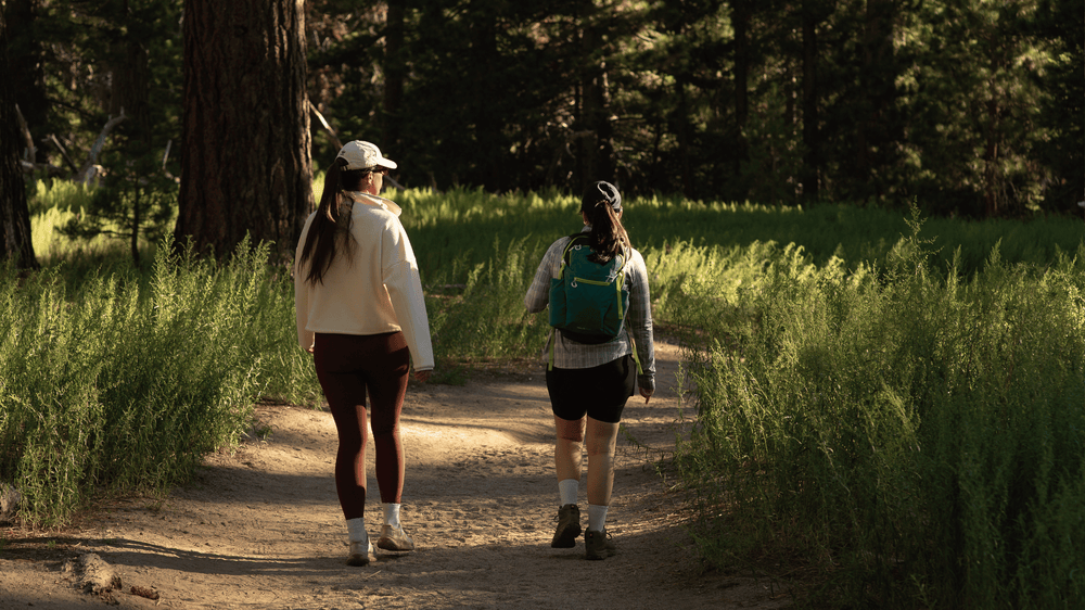Two women walking through the pine forest near the Palm Springs Aerial Tramway Mountain Station