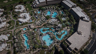 Overhead view of Grand Hyatt Indian Wells' pools, water slides, cabanas and hotel buildings.