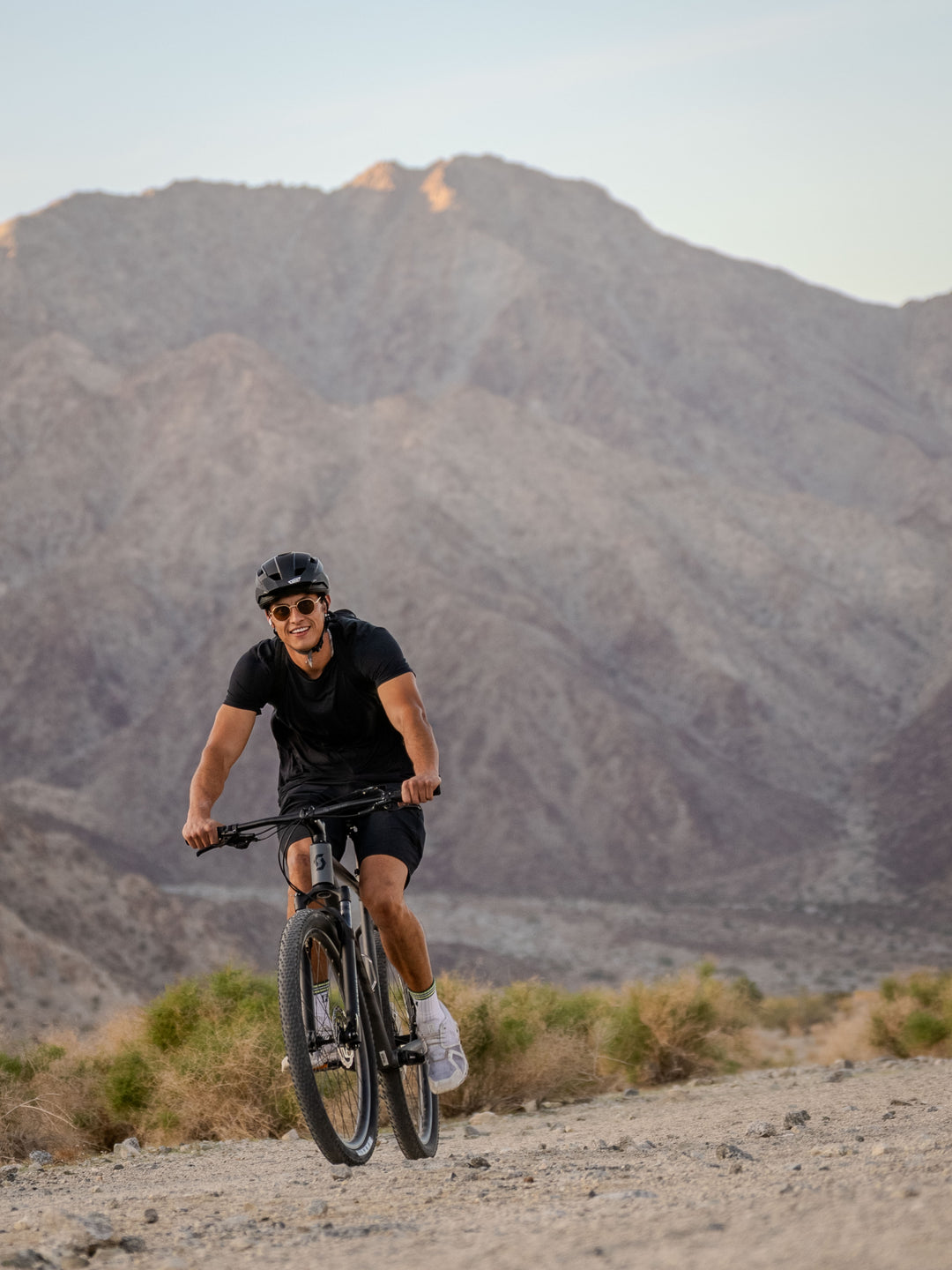 Person riding a mountain bike in La Quinta Cove Hiking area. Professional quality.