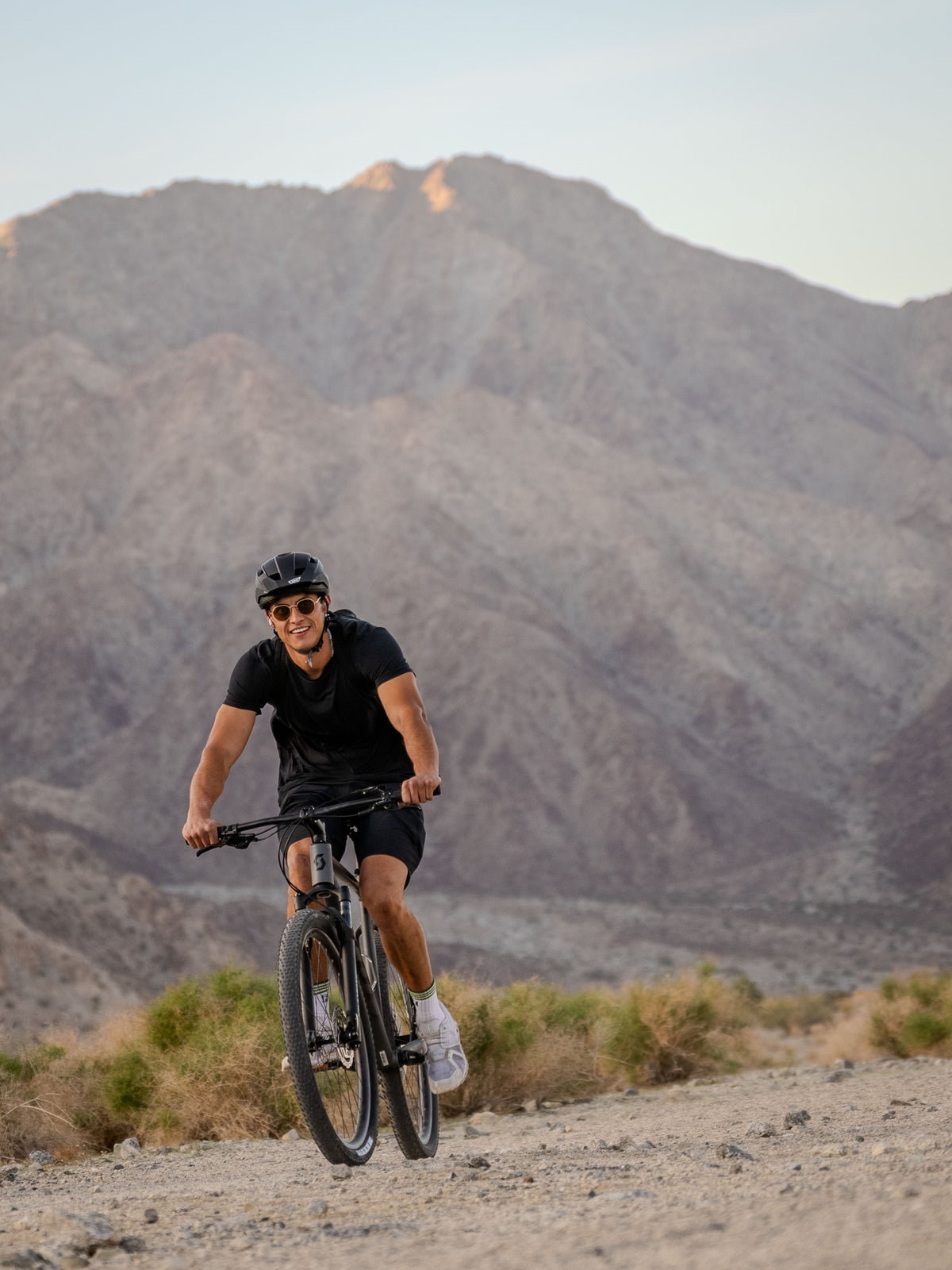Person riding a mountain bike in La Quinta Cove Hiking area. Professional quality.