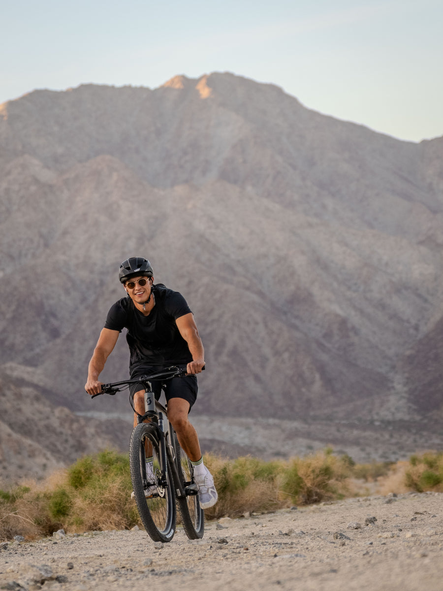 Person riding a mountain bike in La Quinta Cove Hiking area. Professional quality.