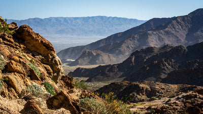 Rocky desert mountains with sunlit ridges and layered mountain ranges in La Quinta, California.