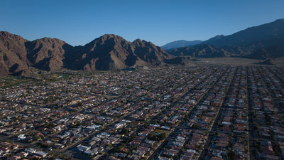 Panoramic view of La Quinta Cove framed by rocky Santa Rosa Mountain ridges and open desert.