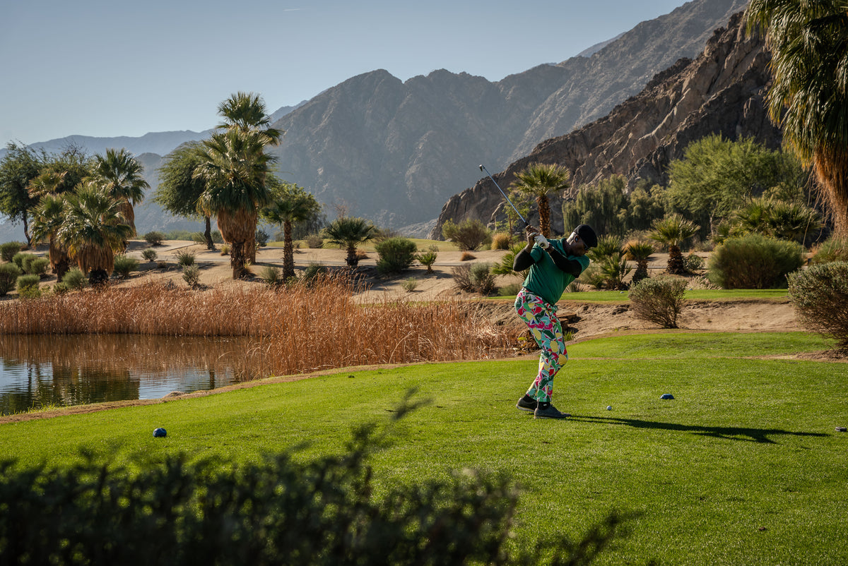 Person playing silverrock golf on a scenic course with mountains and water in the background