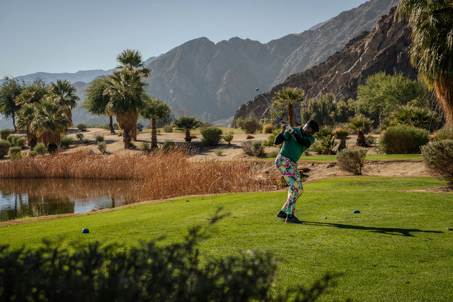 Person playing silverrock golf on a scenic course with mountains and water in the background