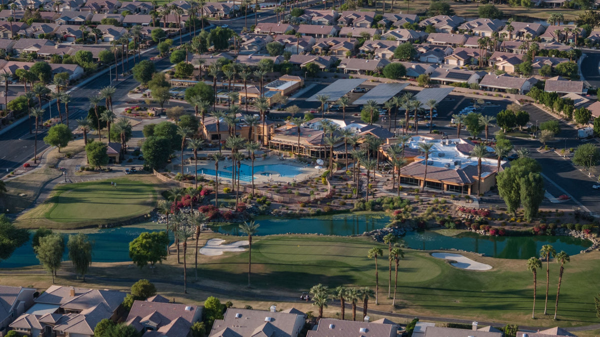 Aerial view of Sunset View Clubhouse, golf, lakes, and homes