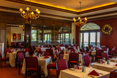 Bellatrix dining room at The Classic Club with chandeliers and a wine wall.