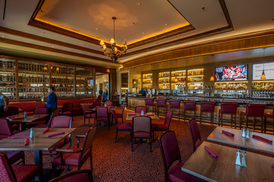 Bellatrix bar and dining area at The Classic Club with a glass wine display.