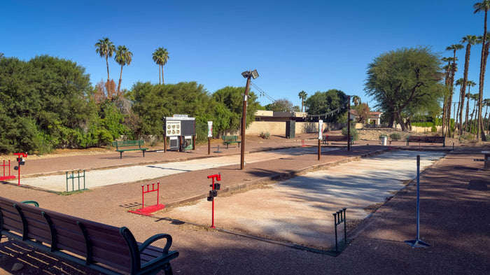 Outdoor bocce courts with benches, palms and surrounding landscaping at Bermuda Dunes Country Club, California. Photograph by Mark Miller.