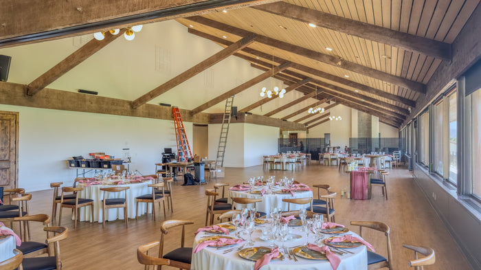 Clubhouse dining room with exposed timber beams and tables set for dining at Bermuda Dunes Country Club, California. Photograph by Mark Miller.