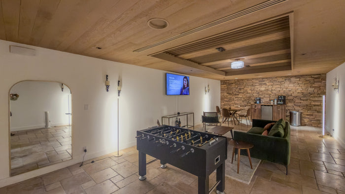 Clubhouse game room with a foosball table and television at Bermuda Dunes Country Club, California. Photograph by Mark Miller.