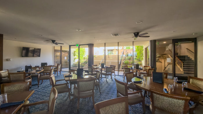 Clubhouse seating area with glass doors facing the golf course at Bermuda Dunes Country Club, California. Photograph by Mark Miller.
