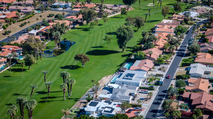 Aerial view along a fairway bordered by residential streets and homes at Bermuda Dunes Country Club, California. Photograph by Mark Miller.