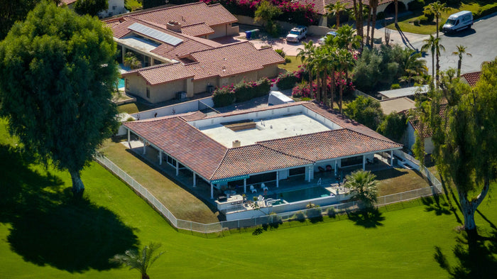 Aerial view of a home with lawn beside the golf course at Bermuda Dunes Country Club, California. Photograph by Mark Miller.