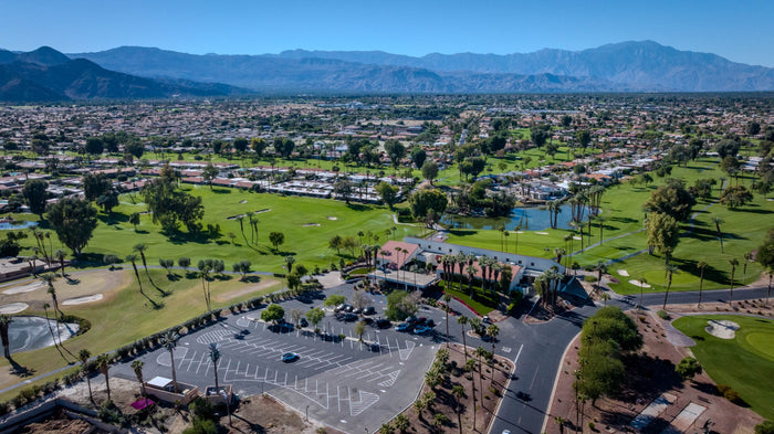 Panoramic aerial view of golf fairways, a lake and surrounding homes at Bermuda Dunes Country Club, California. Photograph by Mark Miller.
