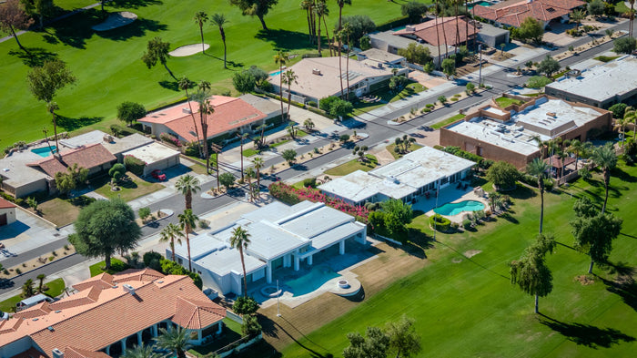 Aerial view of homes, swimming pools and a palm-lined fairway at Bermuda Dunes Country Club, California. Photograph by Mark Miller.