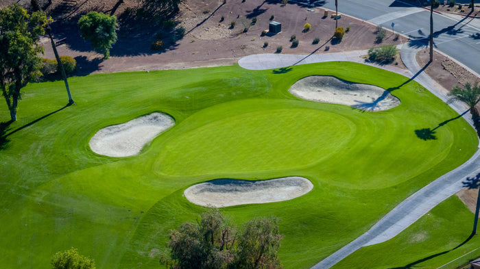 Aerial view of a golf green surrounded by sand bunkers at Bermuda Dunes Country Club, California. Photograph by Mark Miller.