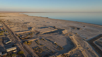 Exposed shoreline, scattered structures and calm water at Bombay Beach on the Salton Sea, photographed by Mark Miller in September 2026
