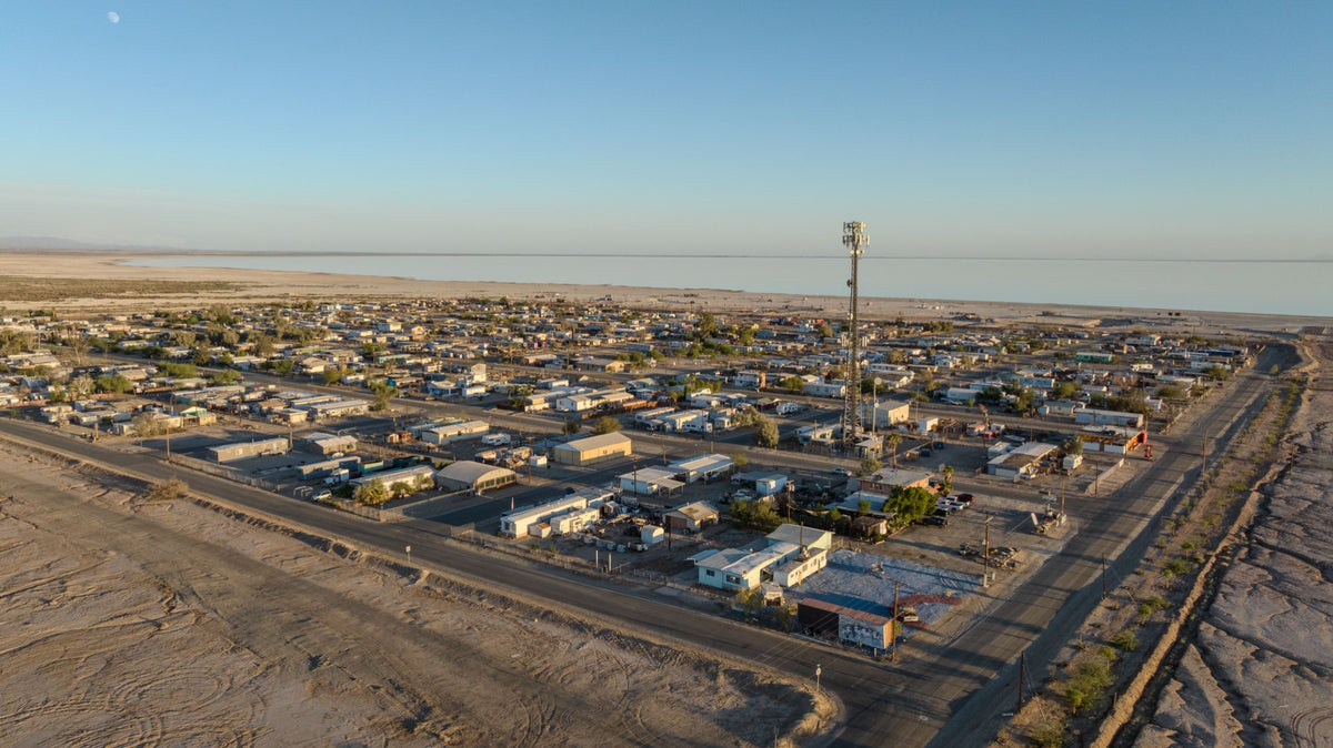 Aerial view of Bombay Beach homes, streets and the Salton Sea in September 2026, photographed by Mark Miller