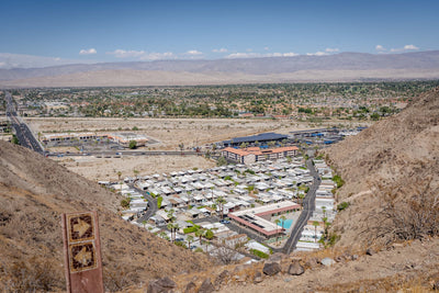 Original photograph: trail marker and a view between desert hills toward Rancho Mirage and the Coachella Valley.