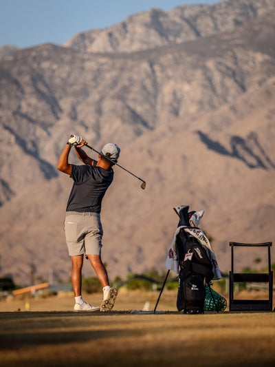 Portrait view of a golfer swinging beneath rugged mountains at Cimarron Golf Resort. Photo by Mark Miller, Cathedral City, September 26, 2026.