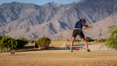 Golfer teeing off with rugged mountains behind Cimarron Golf Resort. Photo by Mark Miller, September 26, 2026.