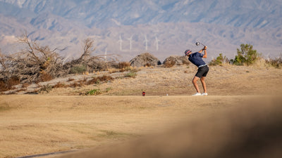 Golfer playing a shot beside sandy terrain and desert vegetation at Cimarron Golf Resort. Photo by Mark Miller, September 26, 2026.