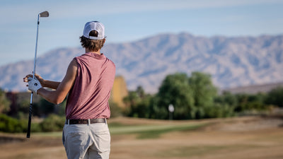 Golfer watching play with mountains and desert landscaping in the distance. Photo by Mark Miller, Cathedral City, September 26, 2026.