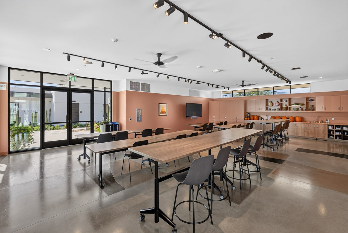 Long worktables, stools and storage cabinets inside Cotino's Creative Studio. Photograph by Mark Miller, October 13, 2026.