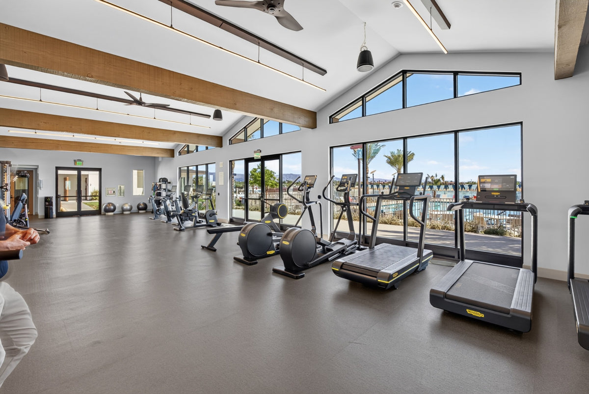 Treadmills and ellipticals beside large windows in Cotino's fitness center. Photograph by Mark Miller, October 13, 2026.